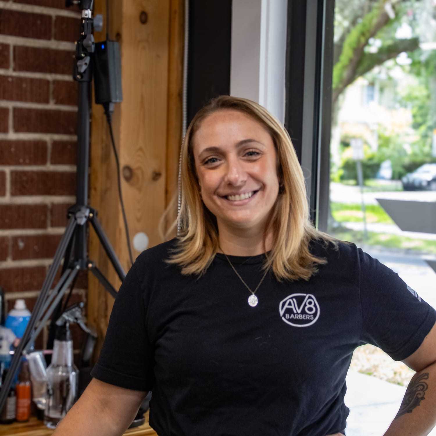 Portrait of Victoria, a professional stylist at Av8 Barbers, showcasing their expertise and style.