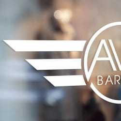 Portrait of Tommy, a professional stylist at Av8 Barbers, showcasing their expertise and style.